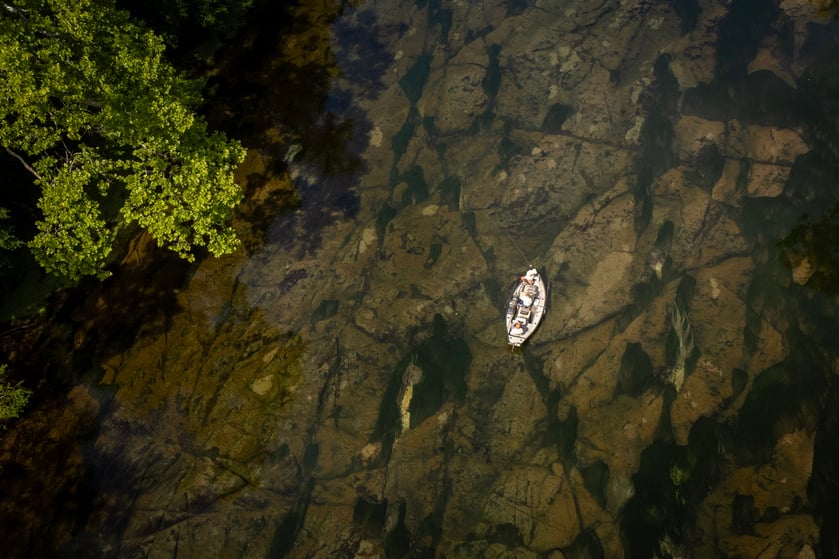 Aerial shot of a drift boat on the South Holston River.