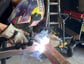 a man welding a beam of steel