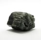a piece of rock art with a green and black stone