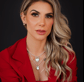 a woman in a red jacket and a necklace