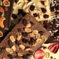 Handcrafted gourmet chocolate bars topped with dried fruits and nuts, elegantly arranged for gifting or indulgence.