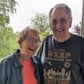 Older married couple smiling with arms around each other