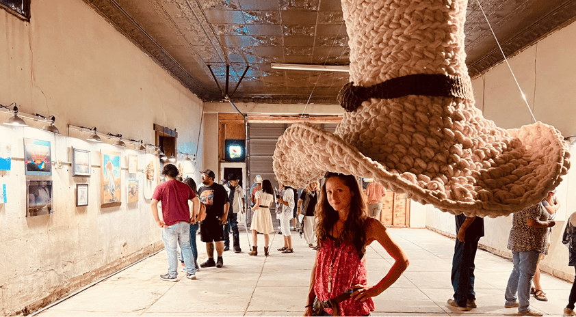 Dundee & Lee artist Emilie Odeile stands beneath her crocheted Tom Mix Wept