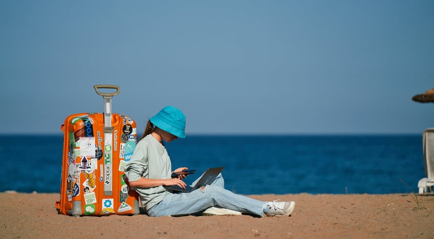 a digital nomad working from a beach