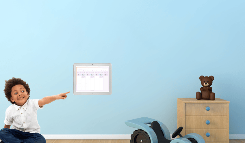 Child in a bedroom looking at the MagicBoard and NurtureIQ application