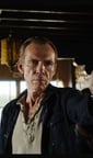 a man holding a gun in a room