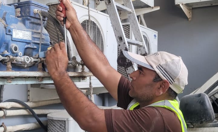a man in a safety vest is working on a machine