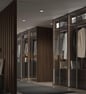 Vestidor elegante con puertas correderas de madera oscura y luz ambiental integrada