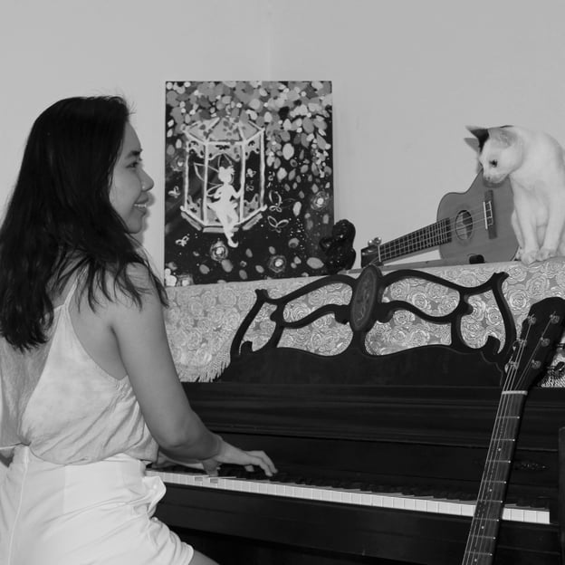 Tracy plays piano for fun and happy with cat pet