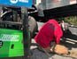 a ma repairing a trailer with a everlast welder next to him