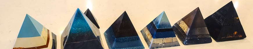 a row of five pyramid shaped resin pieces