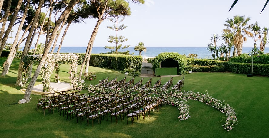 Destination wedding setup and altar in the seaside gardens of Villa El Rincon in Marbella