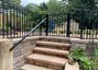 a black and white staircase with a black railing and a black railing