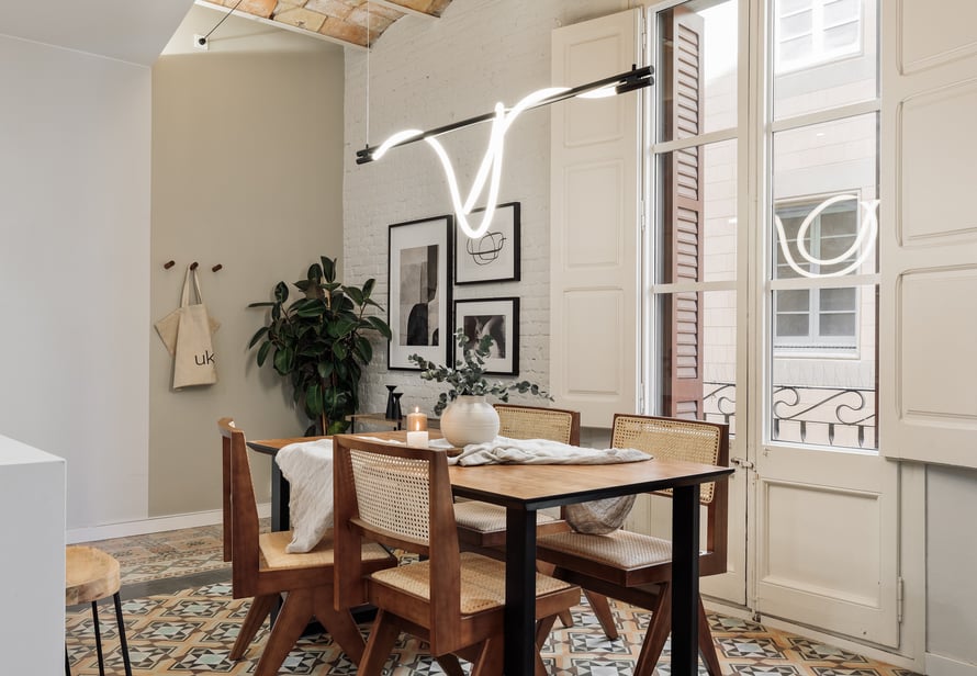 Modern dining room with exposed brick walls, tile floors and Catalan vaulted ceiling interior design