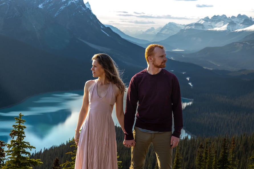 Couple holding hands looking at peyto lake