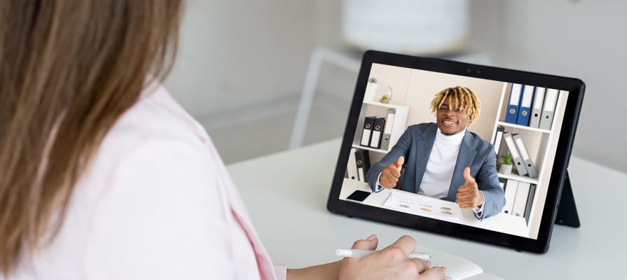 Young man having a video conversation with a woman