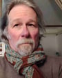 a man with a beard and a scarf around his neck