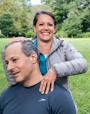 a man and woman smiling and posing for a picture