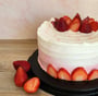 a cake with strawberries and strawberries on a table