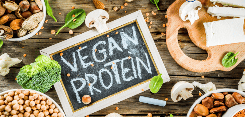 a variety of food items including nuts, mushrooms, broccoli, spinach, and sign in the middle