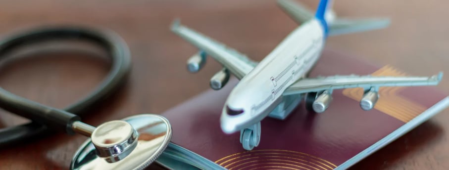a passport and a stethoscope on a table