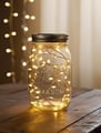 Glass jar filled with glowing LED fairy lights