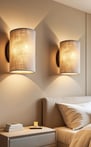 Two soft-glow plug-in sconces with linen shades mounted above bedroom nightstands.