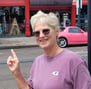 a woman in a purple shirt and sunglasses