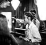 a woman is standing in a bar with a man