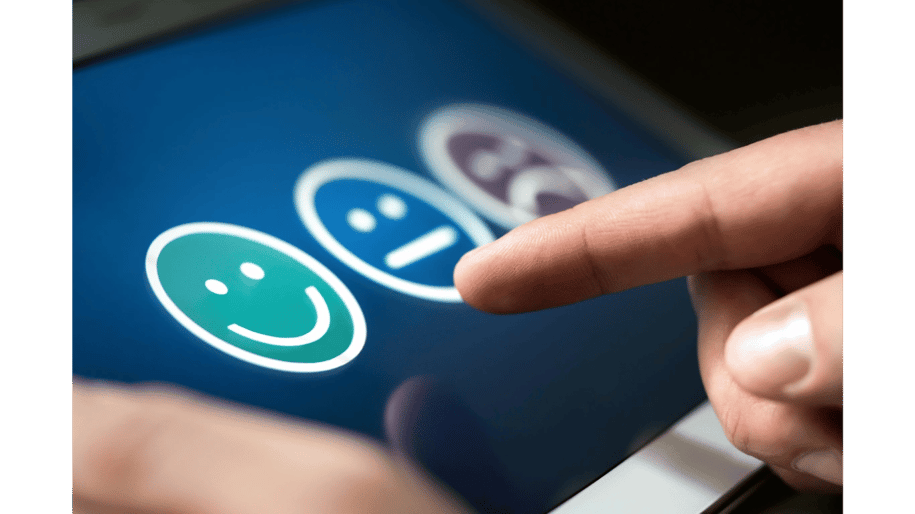 User selecting happy face on touchscreen for customer feedback | Measuring customer engagement