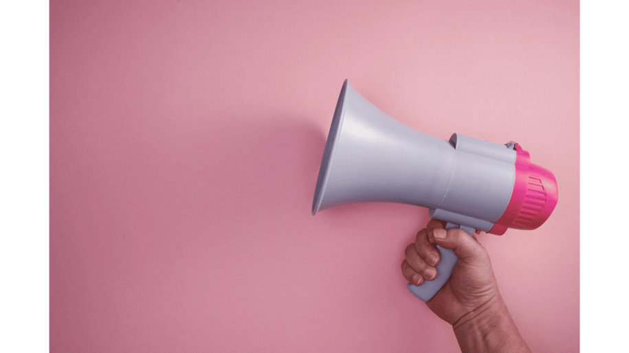 Hand holding a megaphone for blog post promotion | Amplify blog content and increase audience reach