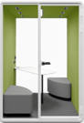 Type T-02: Two-person pod with cushioned benches and corner table, green walls and spotlights