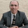 a man in a suit and tie is smiling