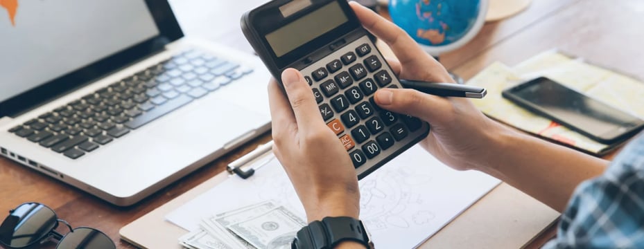 a person holding a calculator and a calculator