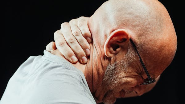 a bald balding man with glasses and a white shirt