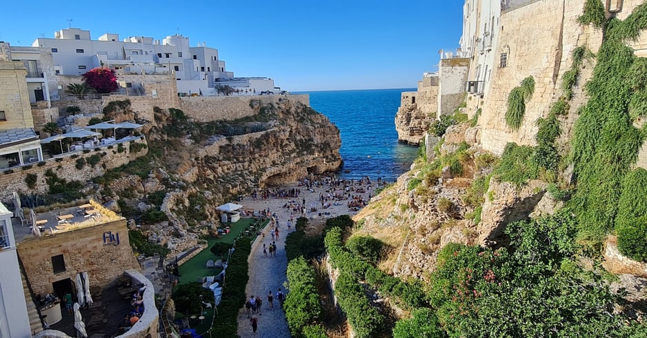 "Polignano a Mare, Italy—coastal town with dramatic limestone cliffs, crystal-clear Adriatic waters,