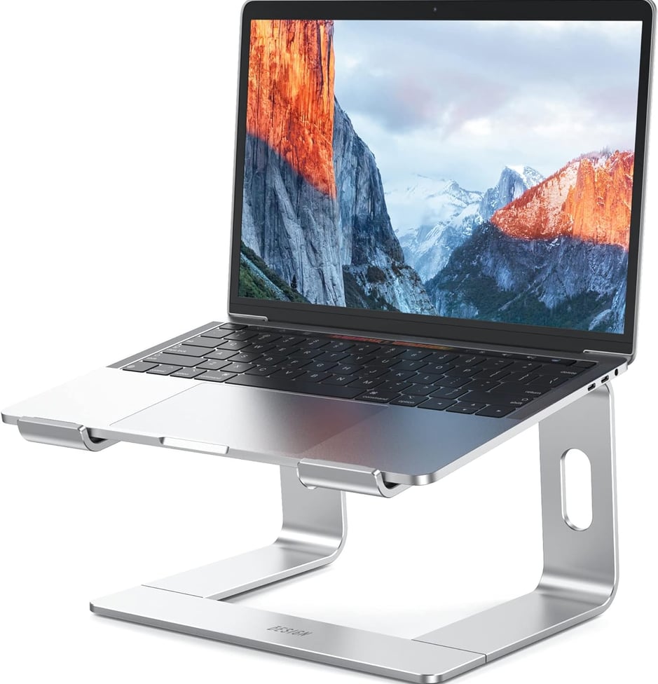 a laptop computer sitting on a stand up
