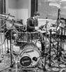 a man playing drums in a recording studio