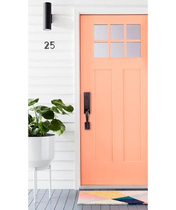 peach painted front door with black hardware 