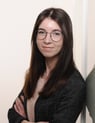 a woman in glasses and a black jacket