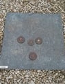 a stone slab with coins and coins on it