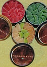 4 round tins with colorful cannabis gummies inside