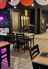 a restaurant with tables and umbrellas and umbrellas
