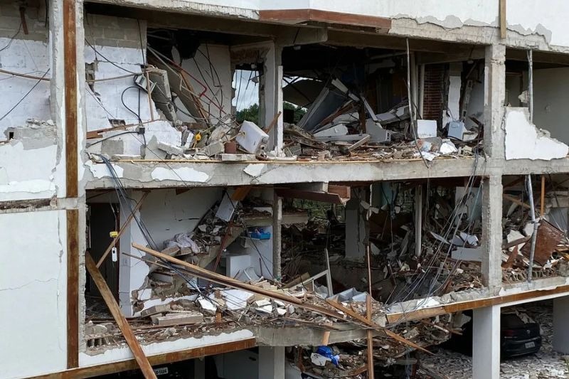a building with a bunch of rubble and debris on the ground
