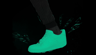 Visual frame - Sneaker walks a step with graphical lightning bolt shapes buzz around with neon green flat color