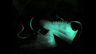 Visual from sneaker-themed animation - plane sneaker laying on the forest ground with glowing neon light shining on the shoes