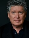 a man with a gray hair and a black shirt