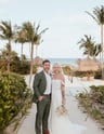 a bride and groom standing in front of a resort