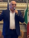 a man in a suit and tie is holding a microphone