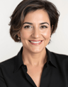 a woman with a black shirt and earrings